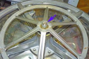 The washing machine drum pulley is not securely fastened.