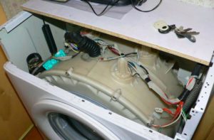 Carefully remove the tank from the washing machine.