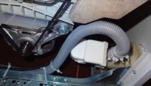 Accessing the washing machine drain hose after removing the back panel