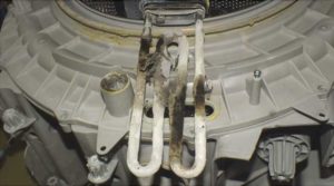 Sediment from unfiltered water on the internal parts of the washing machine