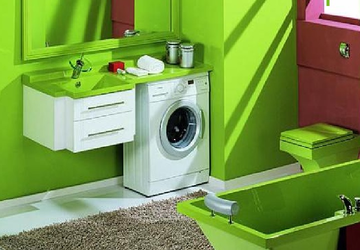 A narrow car in a green bathroom